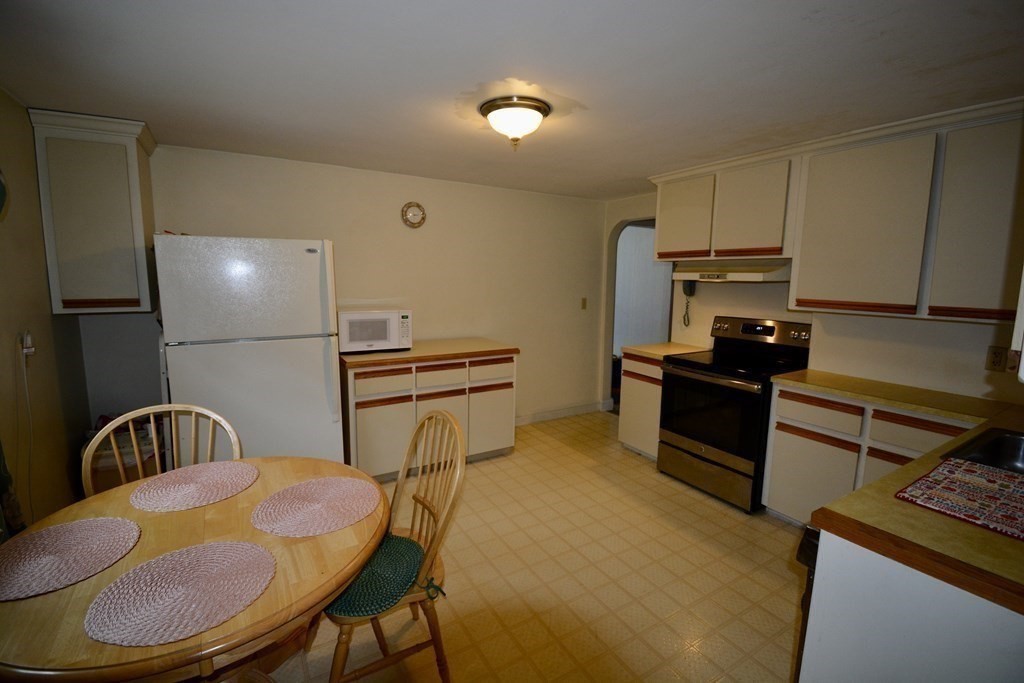 48 Randolph Street Canton, MA 02021 - Photo 15 of 21 a kitchen with stainless steel appliances granite countertop a sink a stove and a refrigerator