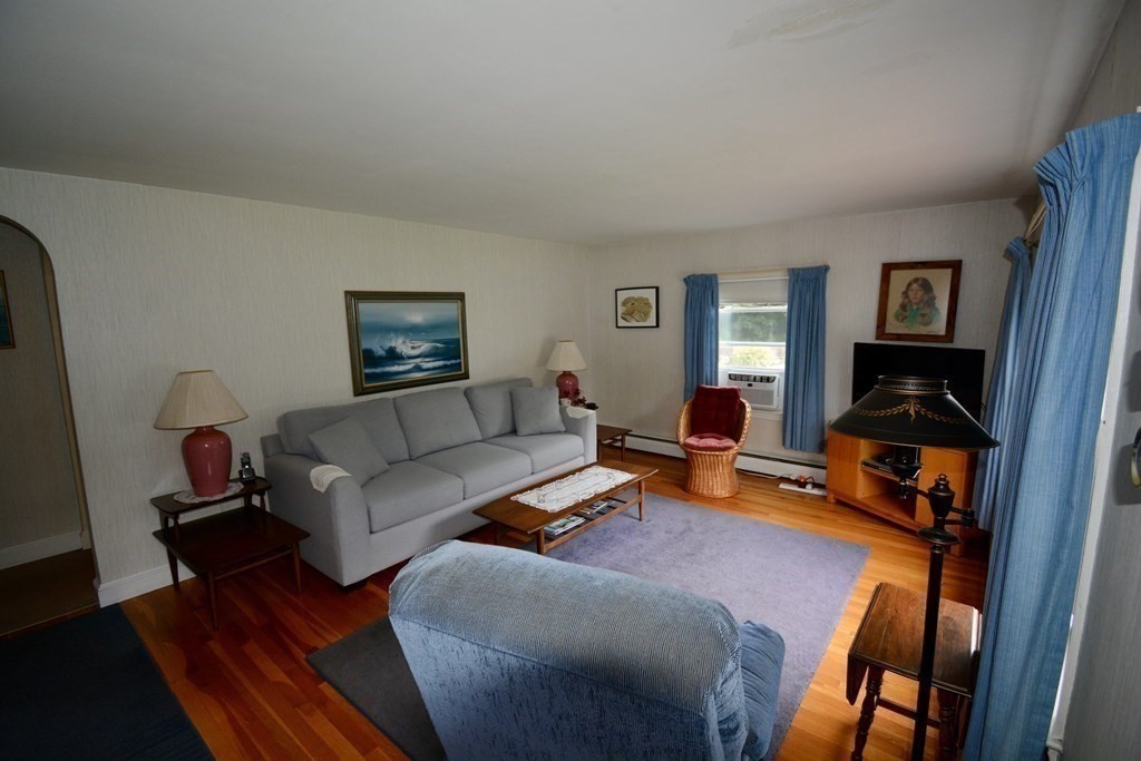 48 Randolph Street Canton, MA 02021 - Photo 3 of 21 a living room with furniture and a wooden floor