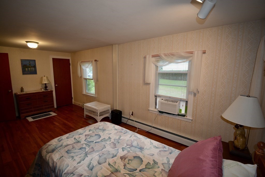 48 Randolph Street Canton, MA 02021 - Photo 10 of 21 a bedroom with a bed and a lamp on dresser