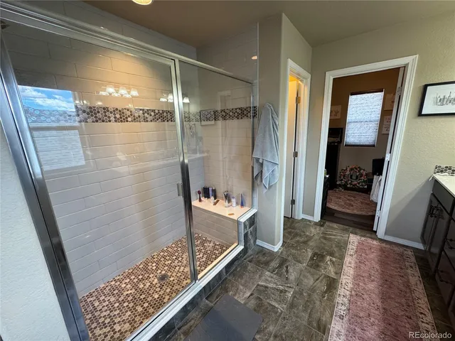 a bathroom with a shower and a bath tub