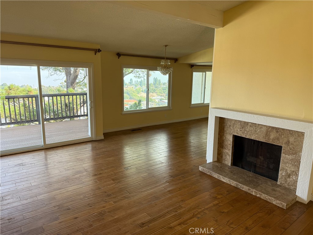 1 Oaktree Lane Rolling Hills Estates, CA 90274 - Photo 4 of 20 an empty room with wooden floor and fireplace