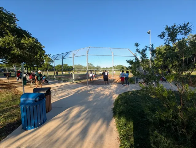 a view of a park with iron fence