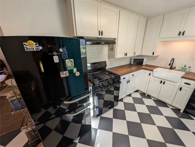 a kitchen with a sink a stove and a refrigerator
