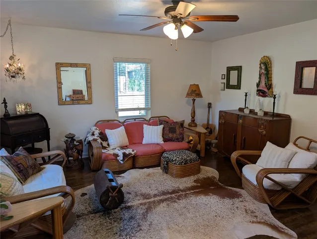 a living room with furniture a ceiling fan and a window