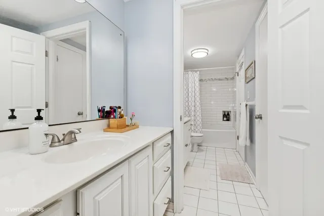 a bathroom with a sink vanity granite and a mirror