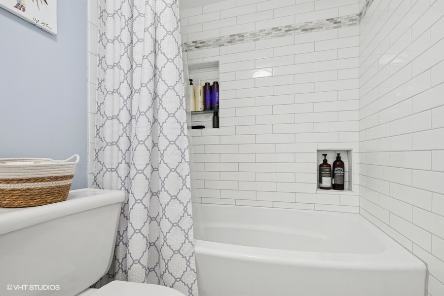 128 Carriage Way Drive, Unit 217B Burr Ridge, IL 60527 - Photo 13 of 20 a bathroom with a toilet and a shower