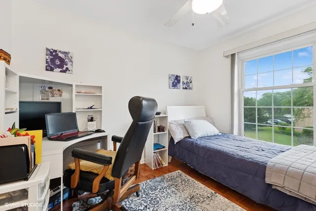 a bedroom with a bed and a desk