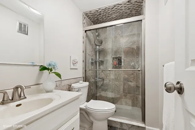 a bathroom with a sink toilet and shower