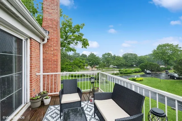a view of a chair and tables on the roof deck