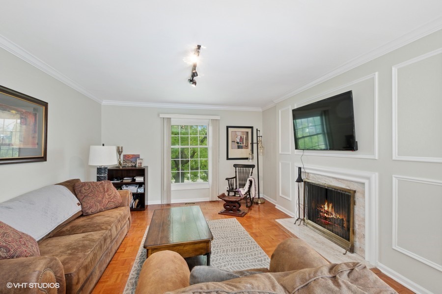 128 Carriage Way Drive, Unit 217B Burr Ridge, IL 60527 - Photo 4 of 20 a living room with furniture fireplace and flat screen tv