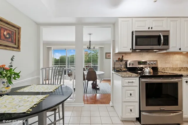 a kitchen with a stove and a white cabinets