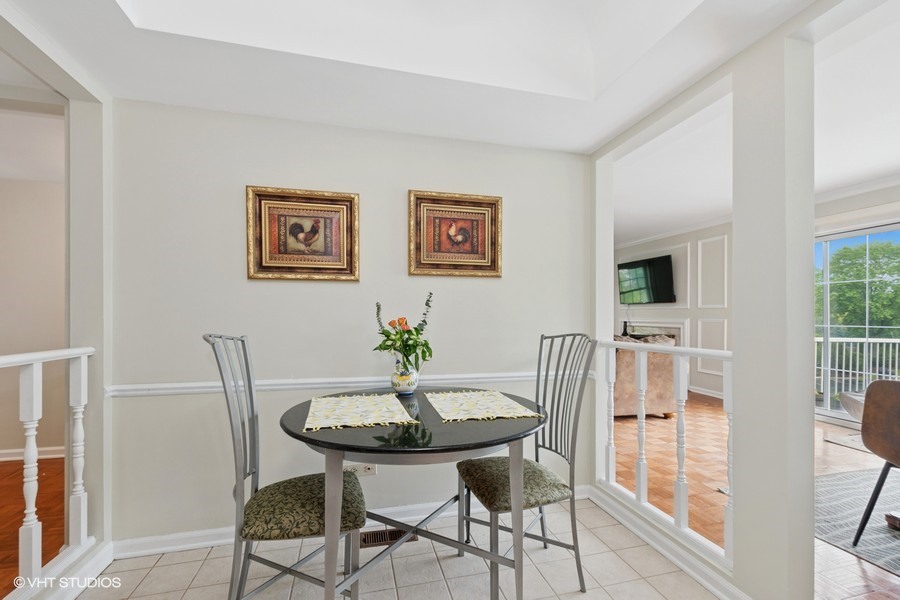 128 Carriage Way Drive, Unit 217B Burr Ridge, IL 60527 - Photo 8 of 20 a view of a dining room with furniture and wooden floor
