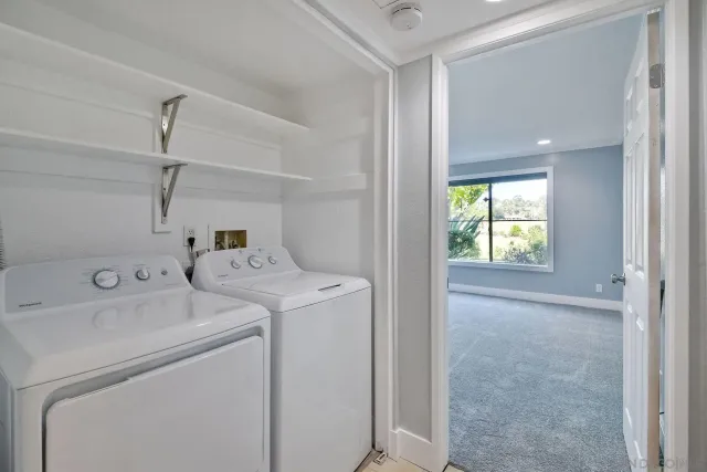 a view of storage and utility room with washer and dryer