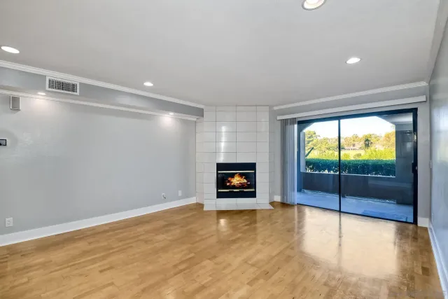 a view of a room with window and fireplace
