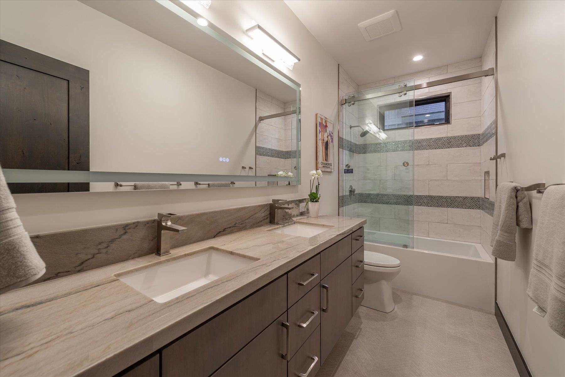 15330 Wolfgang Road Truckee, CA 96161 - Photo 17 of 21 a bathroom with a granite countertop sink a toilet and bathtub