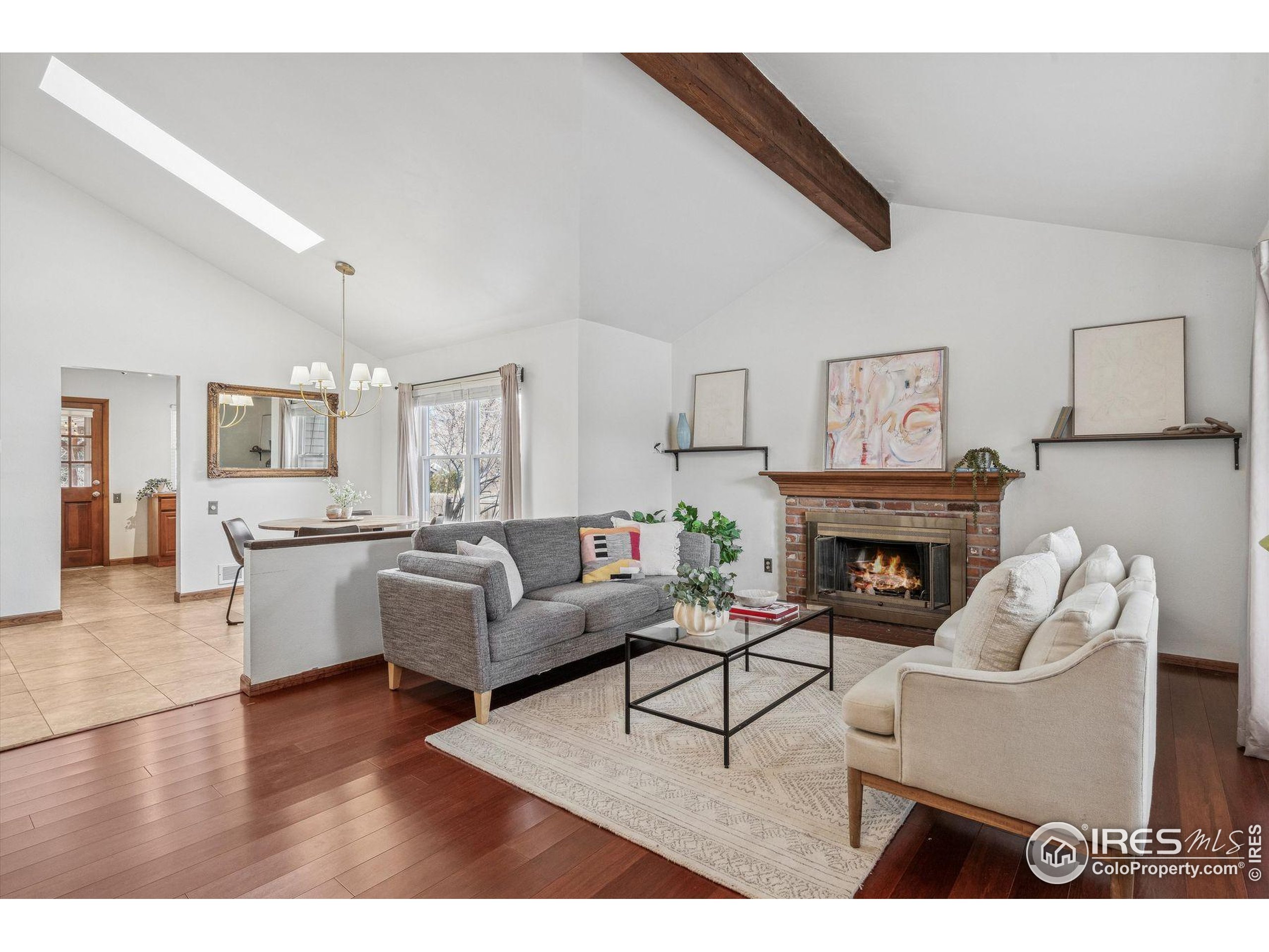 4541 Ensenada Street Denver, CO 80249 - Photo 12 of 35 a living room with furniture a fireplace and a table