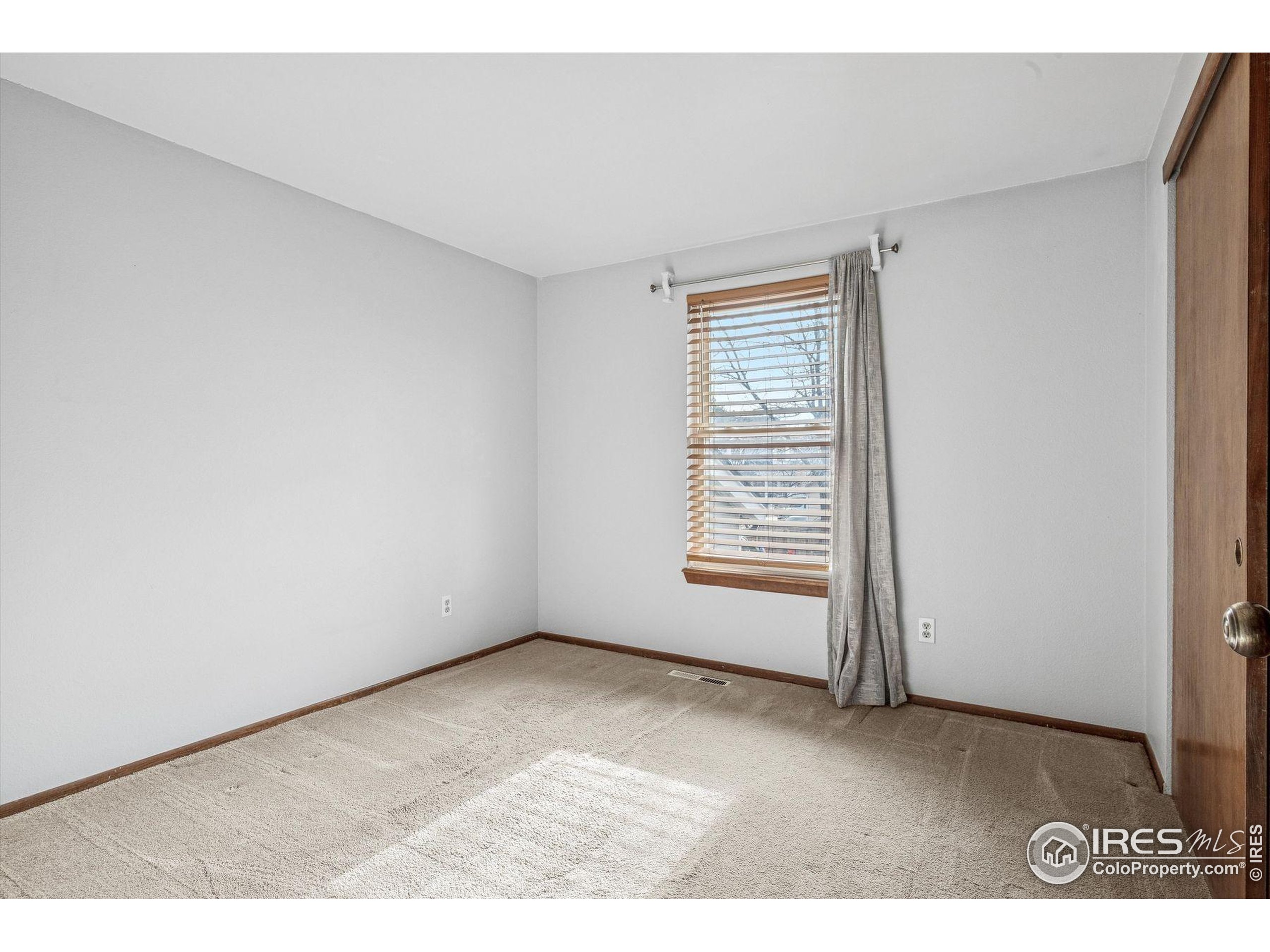 4541 Ensenada Street Denver, CO 80249 - Photo 23 of 35 a view of an empty room with a window