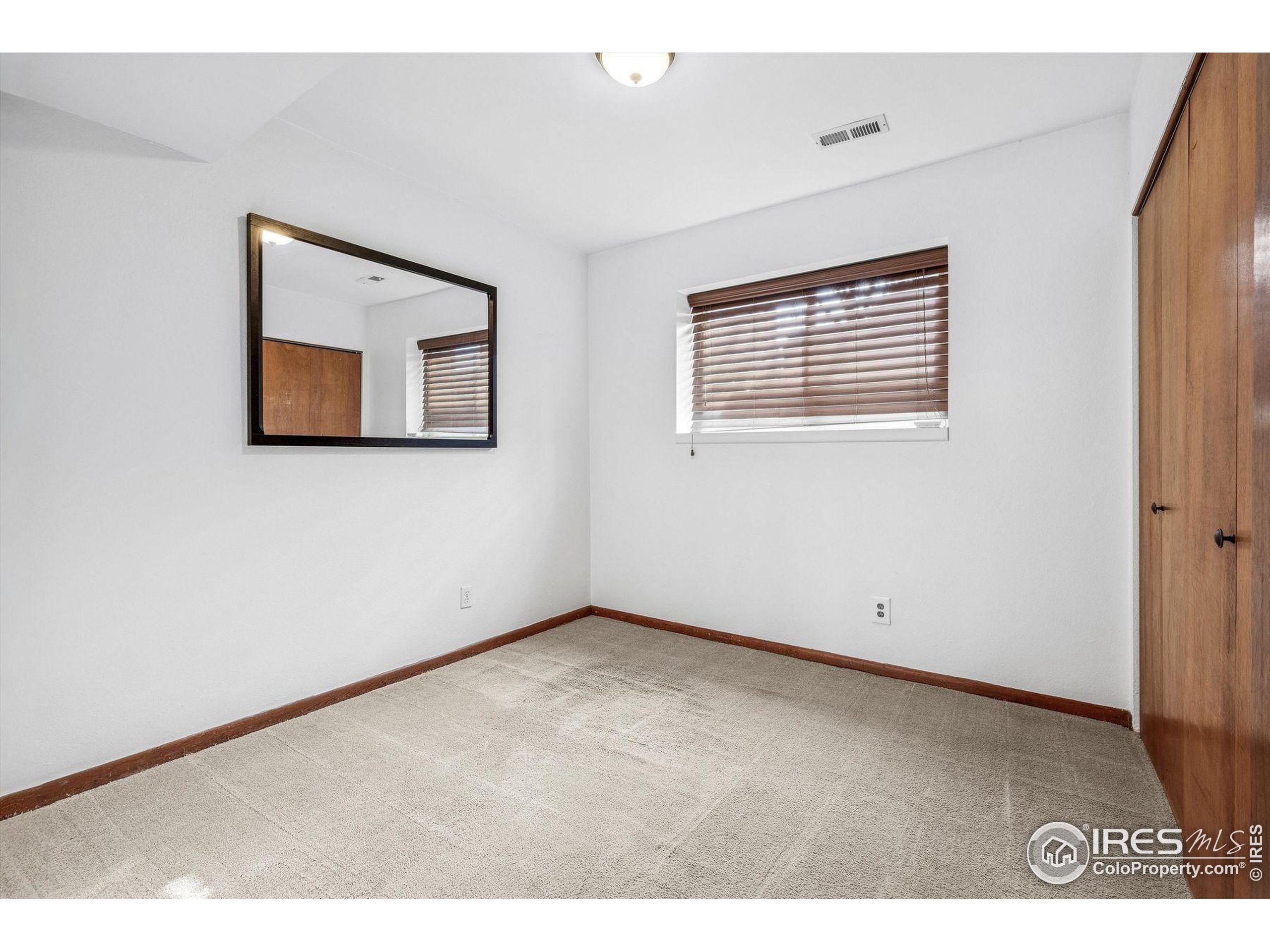 4541 Ensenada Street Denver, CO 80249 - Photo 26 of 35 a view of an empty room with a window