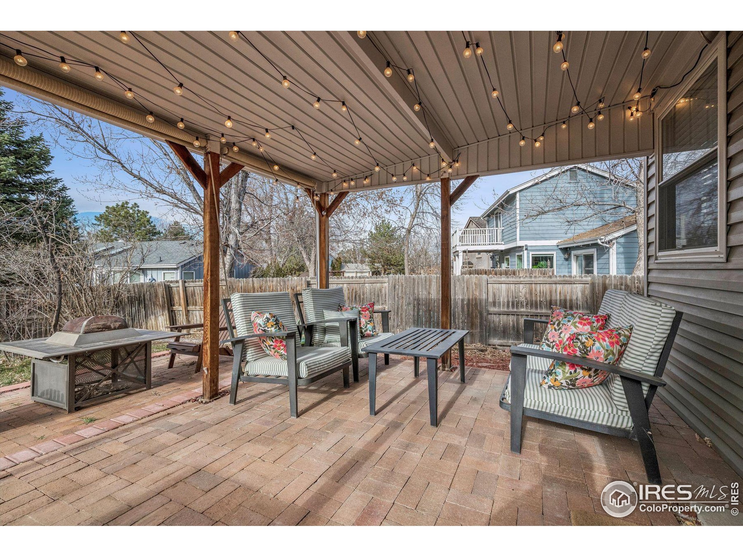4541 Ensenada Street Denver, CO 80249 - Photo 29 of 35 a outdoor living space with furniture and a fireplace