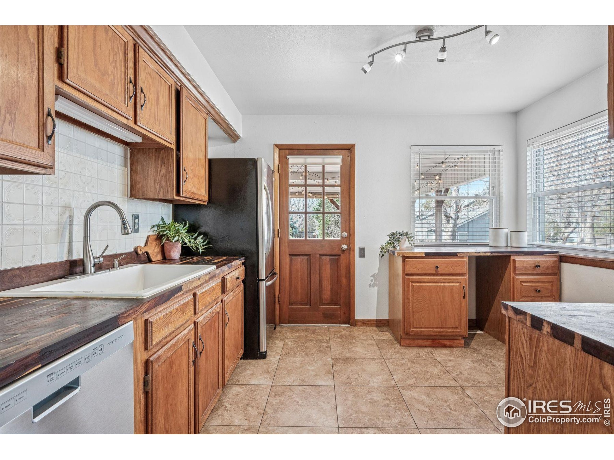 4541 Ensenada Street Denver, CO 80249 - Photo 5 of 35 a kitchen with a sink stove and cabinets