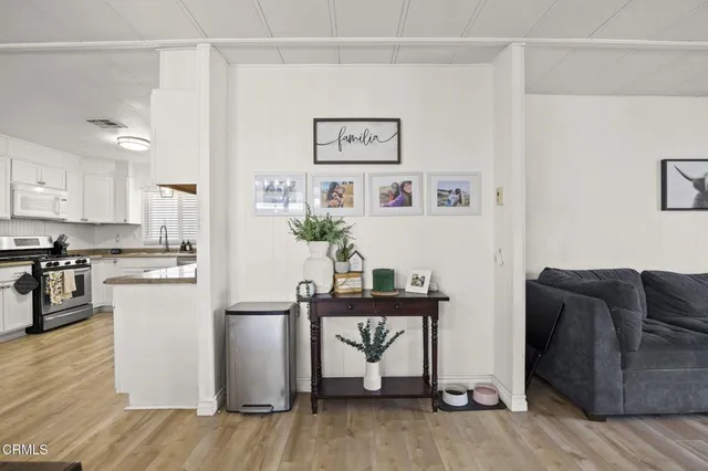 a kitchen with granite countertop white cabinets and refrigerator