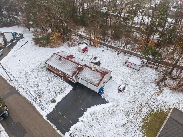 an aerial view of a house with a yard and lake view