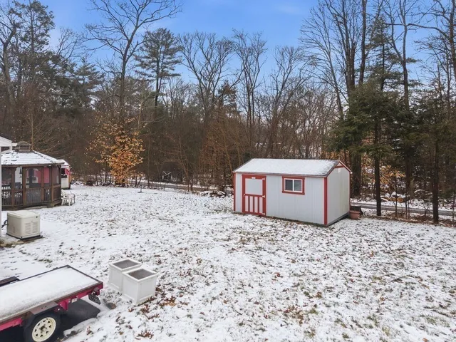 a white house that has a tree in front of it