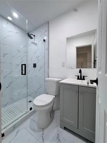 a bathroom with a toilet sink and a shower