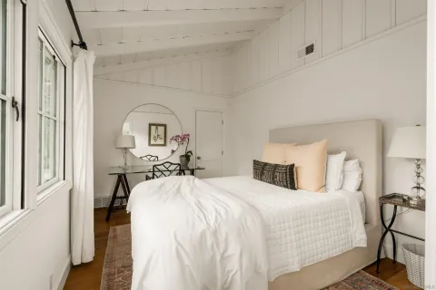 a bedroom with bed and a window