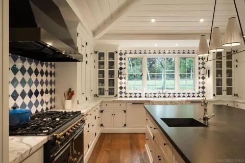 a kitchen with a stove a sink and a refrigerator