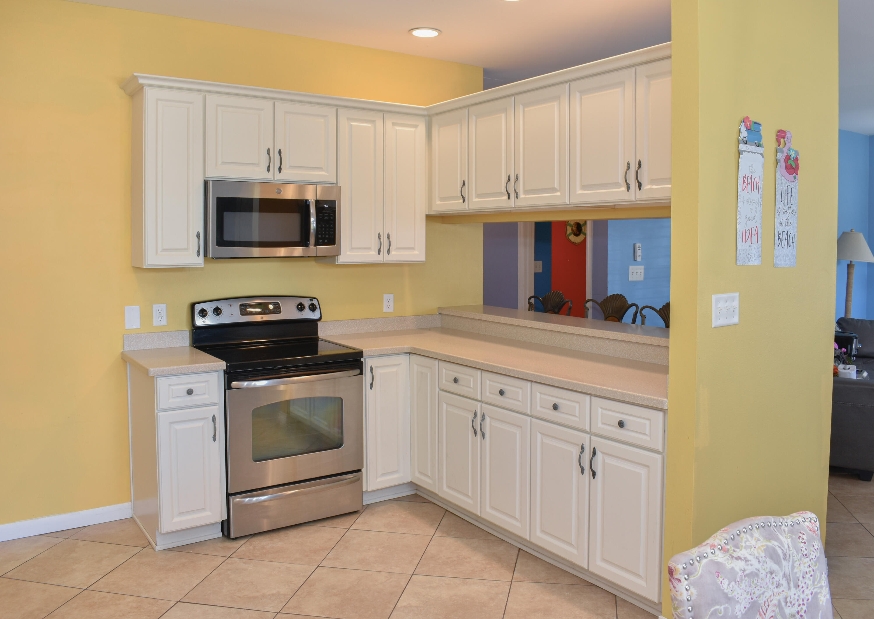 4455 Luke Avenue Destin, FL 32541 - Photo 21 of 44 a kitchen with stainless steel appliances granite countertop a sink and a stove