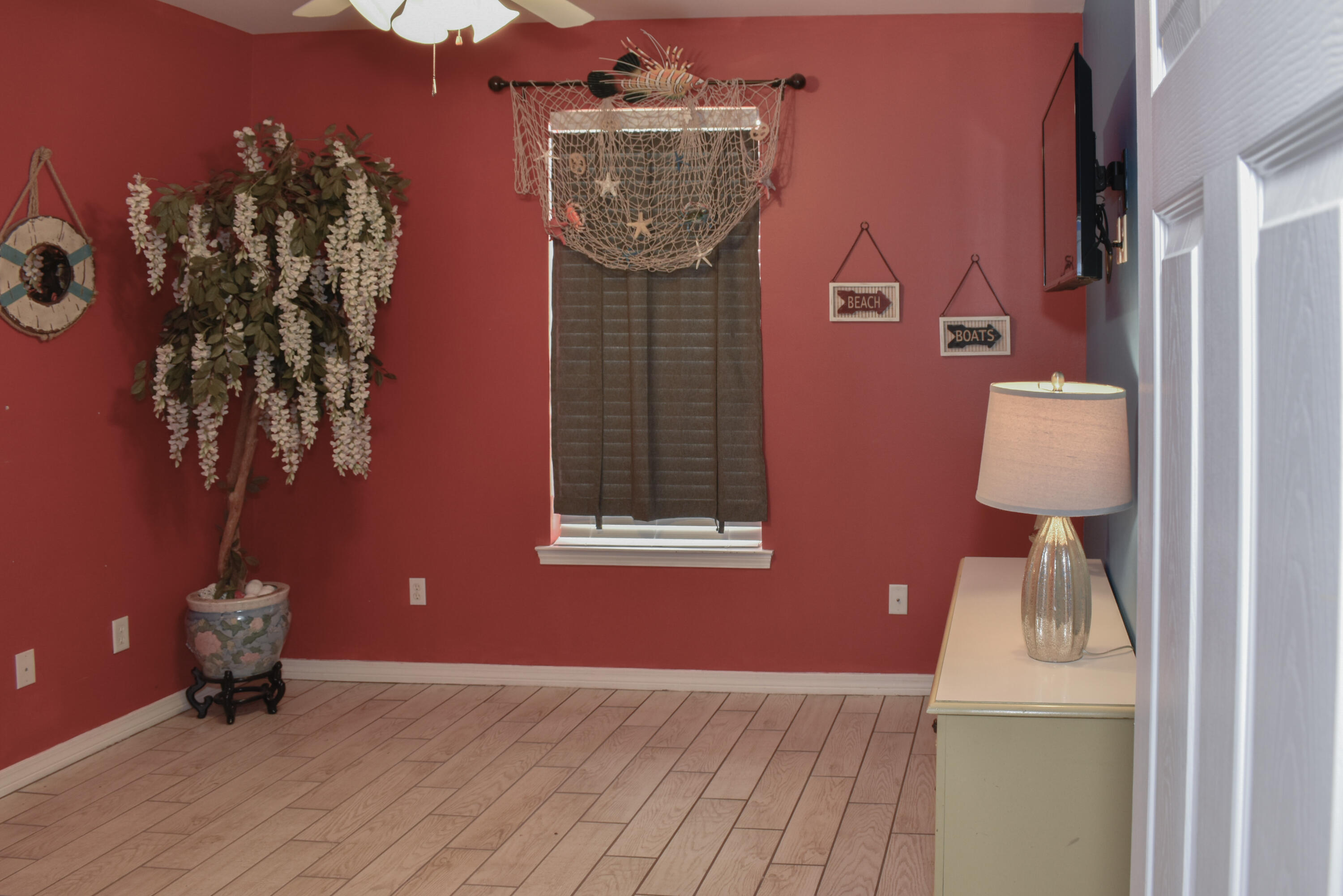 4455 Luke Avenue Destin, FL 32541 - Photo 22 of 44 a view of a livingroom with wooden floor and a chandelier