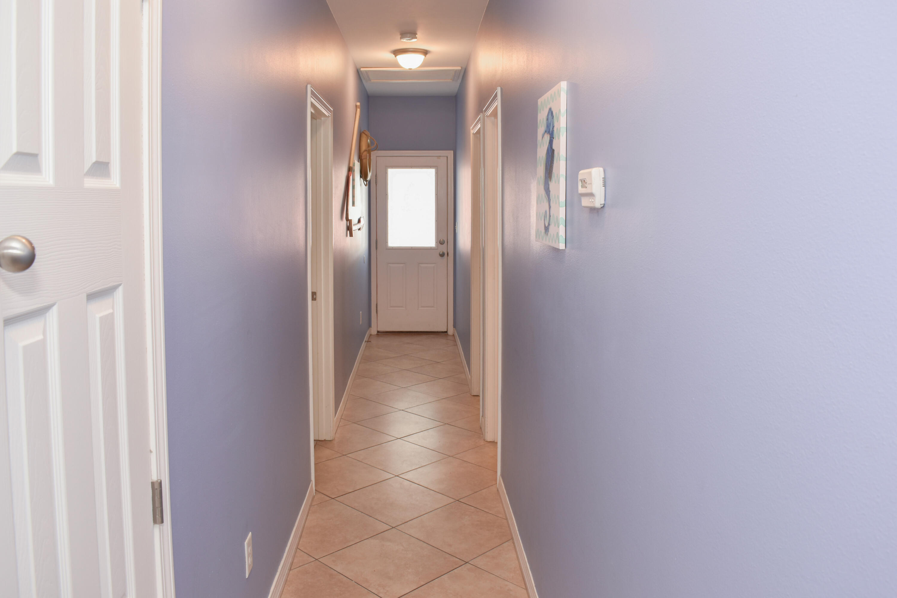 4455 Luke Avenue Destin, FL 32541 - Photo 23 of 44 a view of a hallway with wooden floor