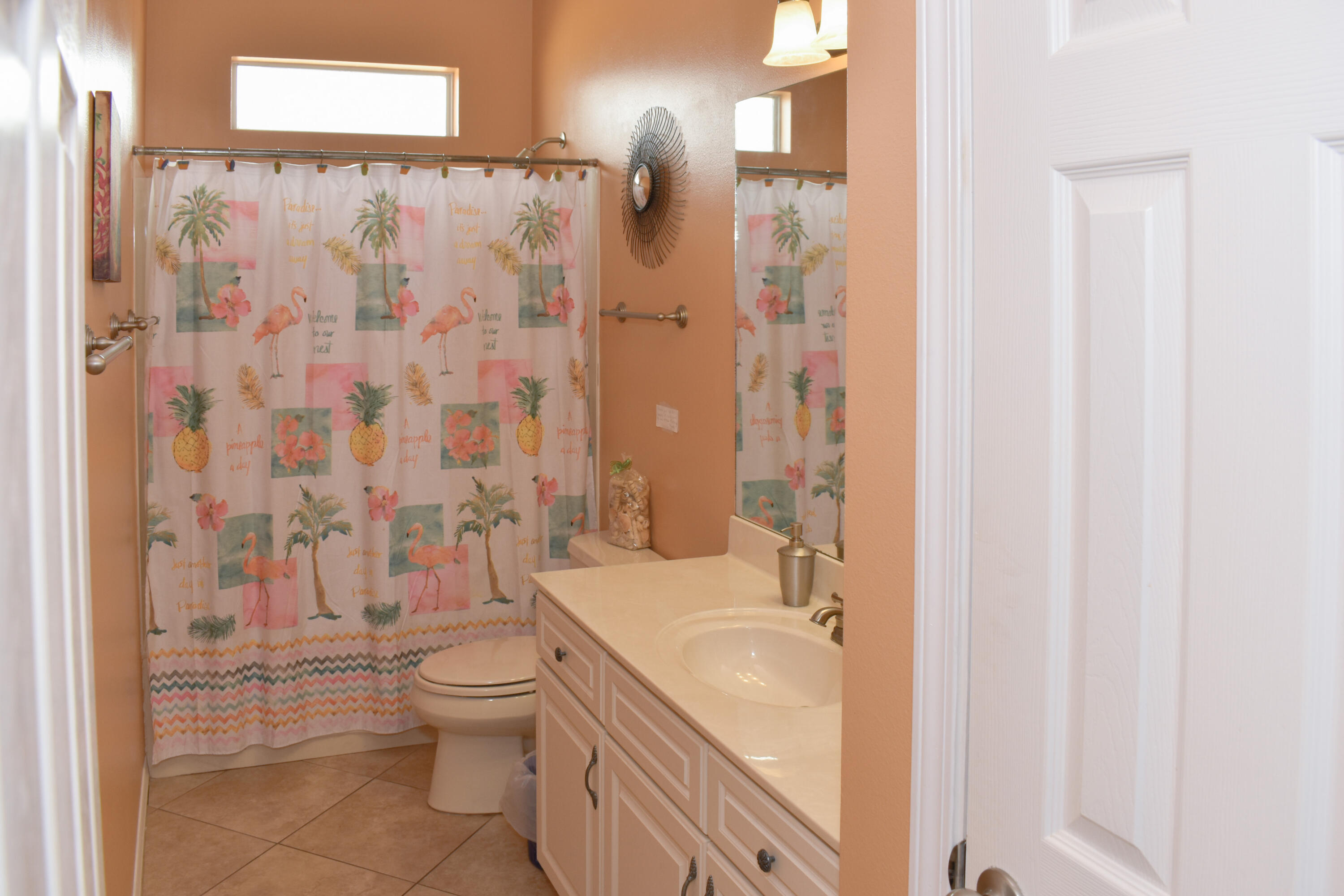 4455 Luke Avenue Destin, FL 32541 - Photo 25 of 44 a bathroom with a granite countertop toilet a sink and a shower