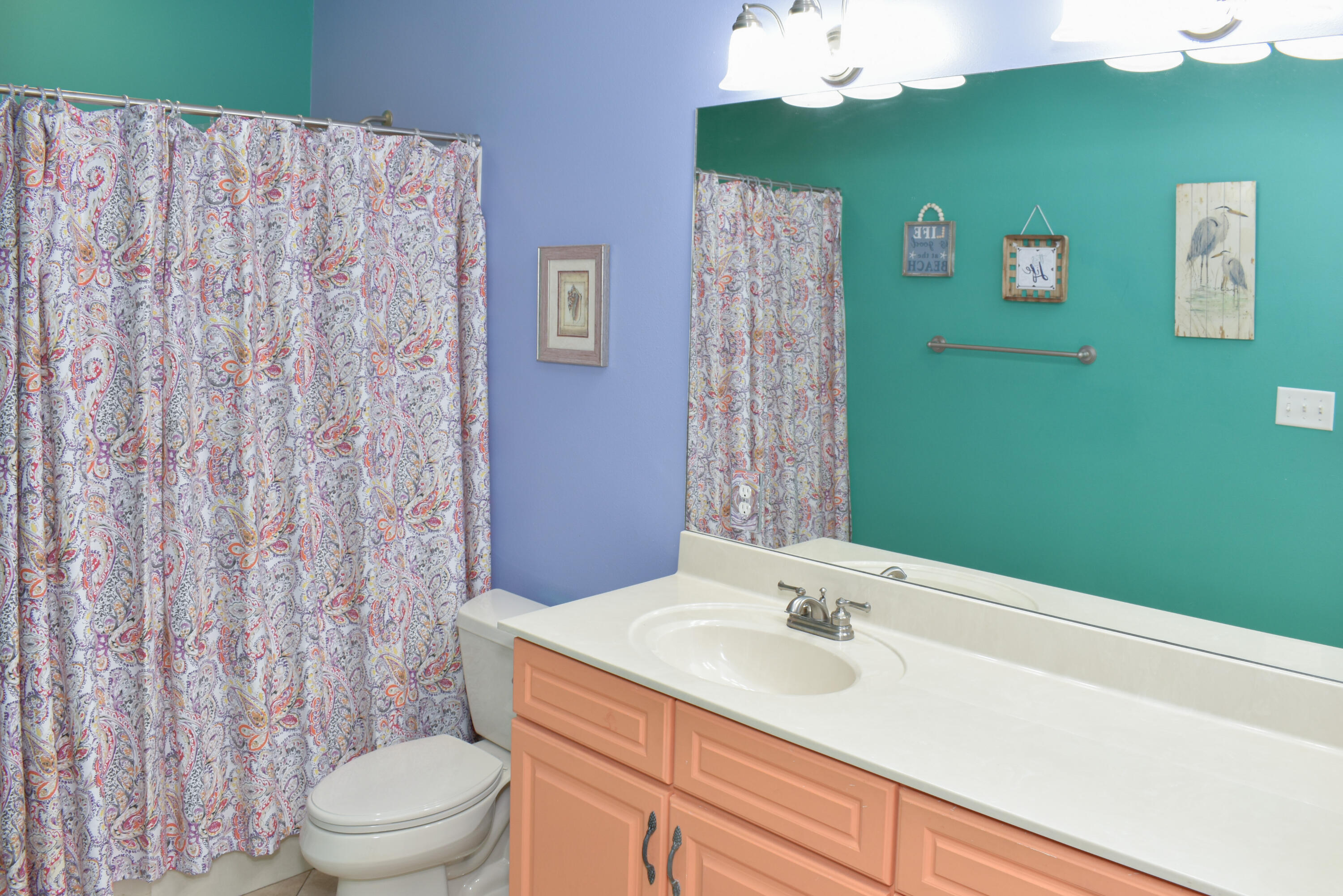 4455 Luke Avenue Destin, FL 32541 - Photo 29 of 44 a bathroom with a sink a toilet and shower curtain