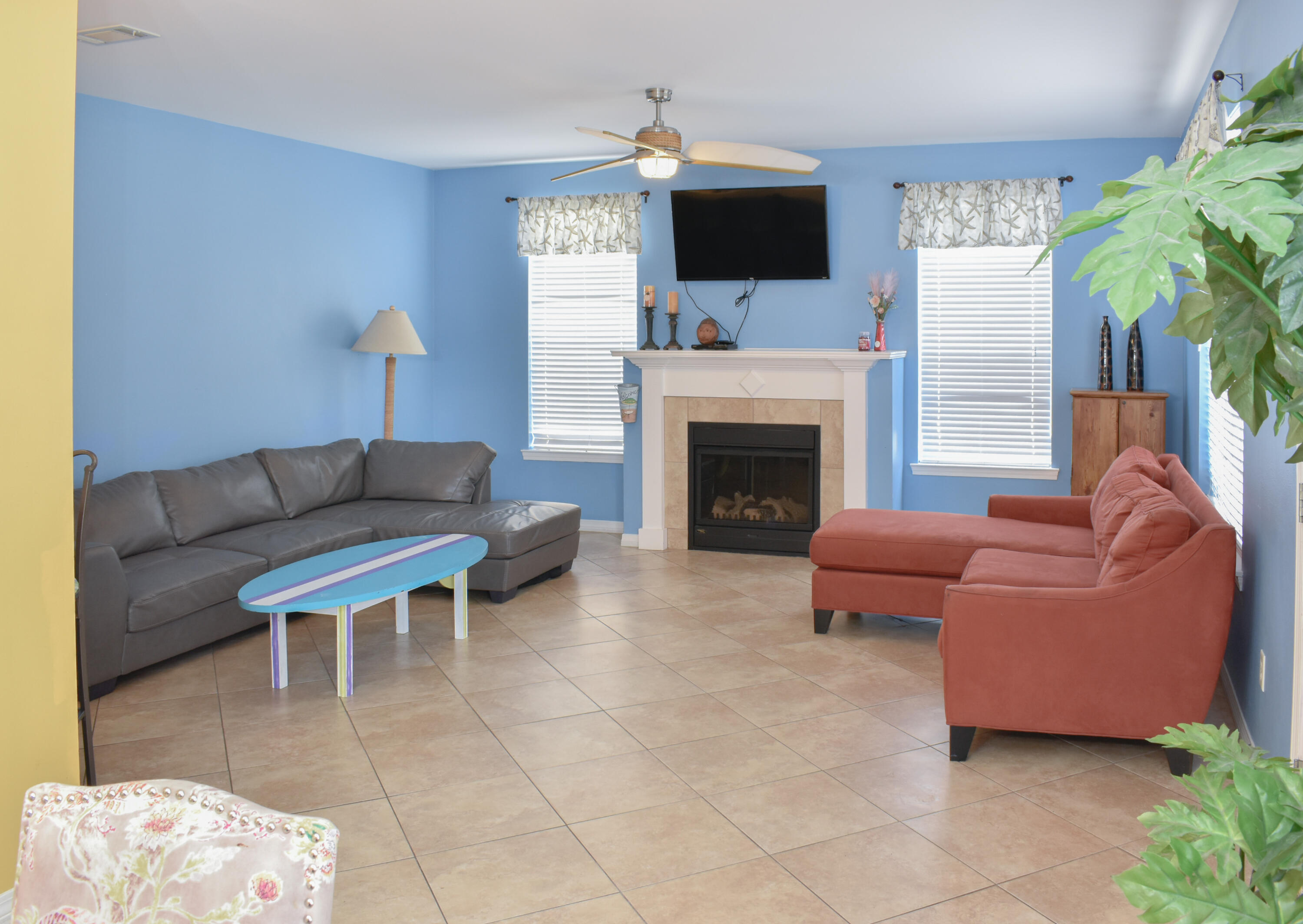 4455 Luke Avenue Destin, FL 32541 - Photo 33 of 44 a living room with furniture a flat screen tv and a fireplace