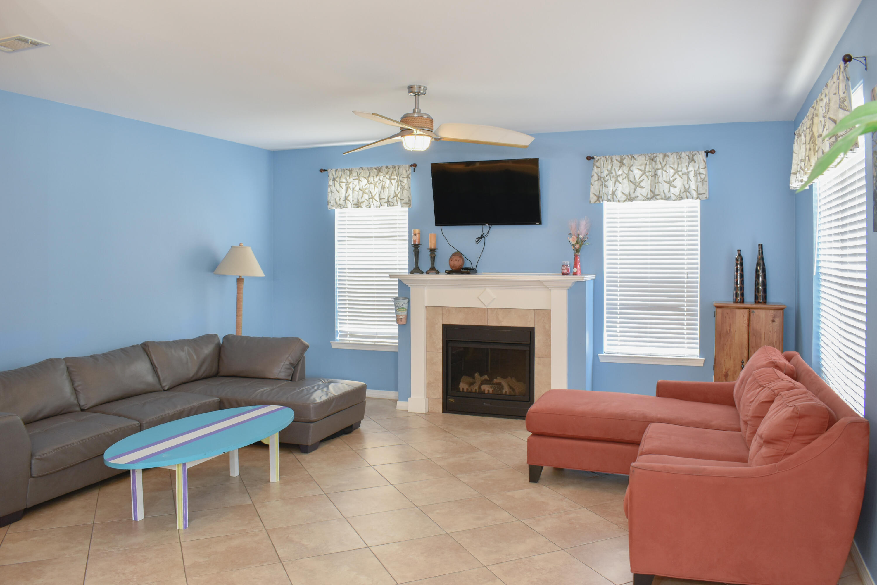 4455 Luke Avenue Destin, FL 32541 - Photo 34 of 44 a living room with furniture a flat screen tv and a fireplace