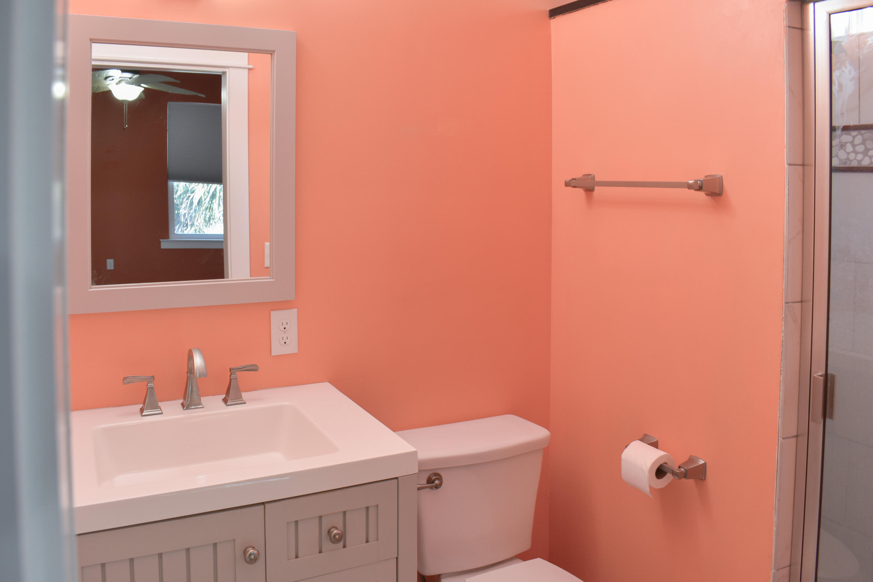 4455 Luke Avenue Destin, FL 32541 - Photo 41 of 44 a bathroom with a sink a toilet and mirror