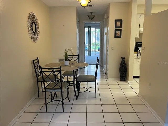 a view of a livingroom with furniture and chandelier fan