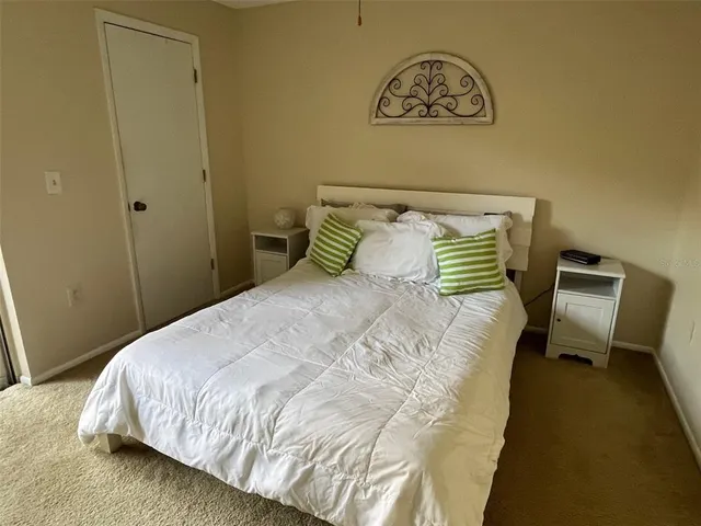 a bedroom with a bed and a chair