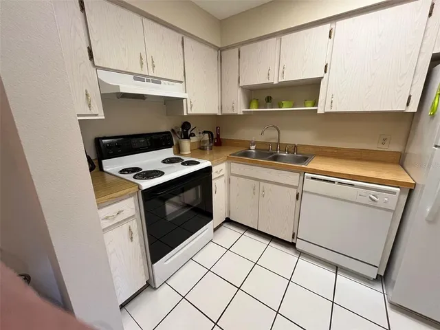 a kitchen with cabinets appliances and a sink