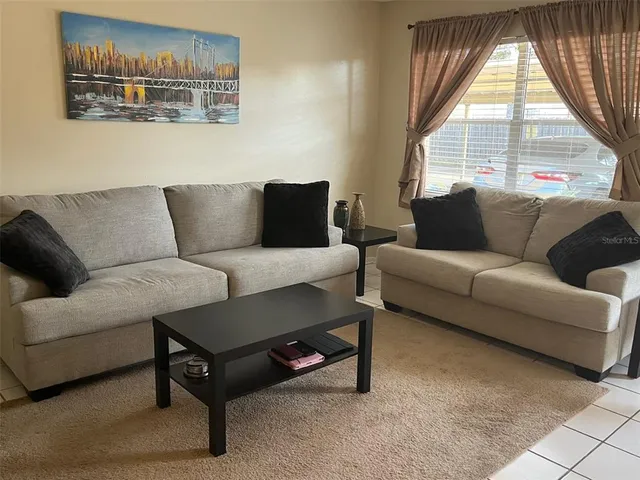 a living room with furniture and a large window