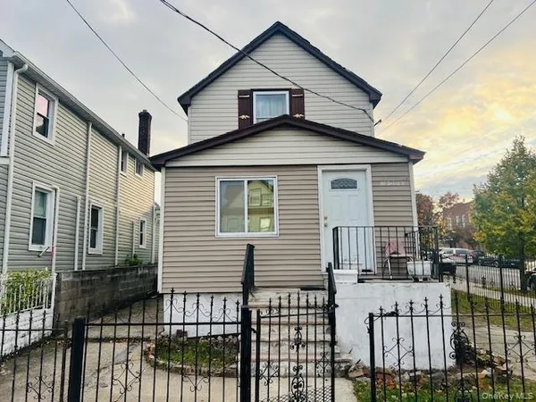 a view of a house with wooden fence
