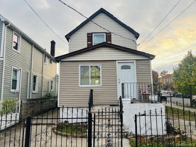a view of a house with wooden fence