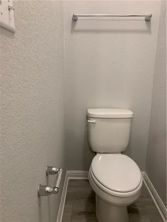 a white toilet sitting next to a shower