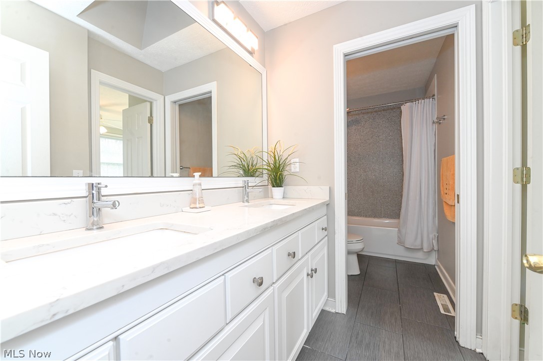 1688 Sheridan Road South Euclid, OH 44121 - Photo 27 of 48 Full bathroom with shower / tub combo, toilet, tile floors, and dual vanity