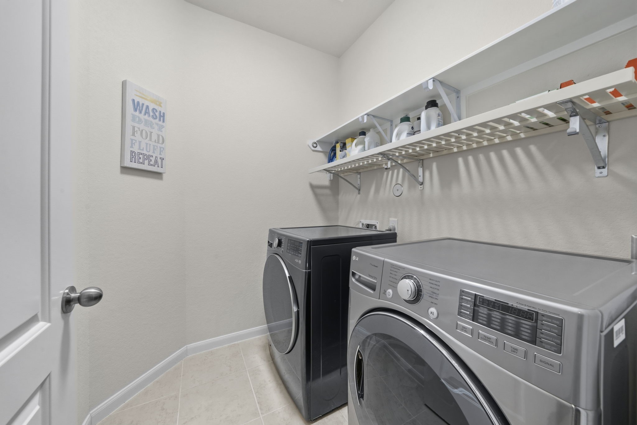 16731 Doubletree Ranch Drive Cypress, TX 77433 - Photo 14 of 44 The laundry has built-in overhead shelving for laundry essentials.