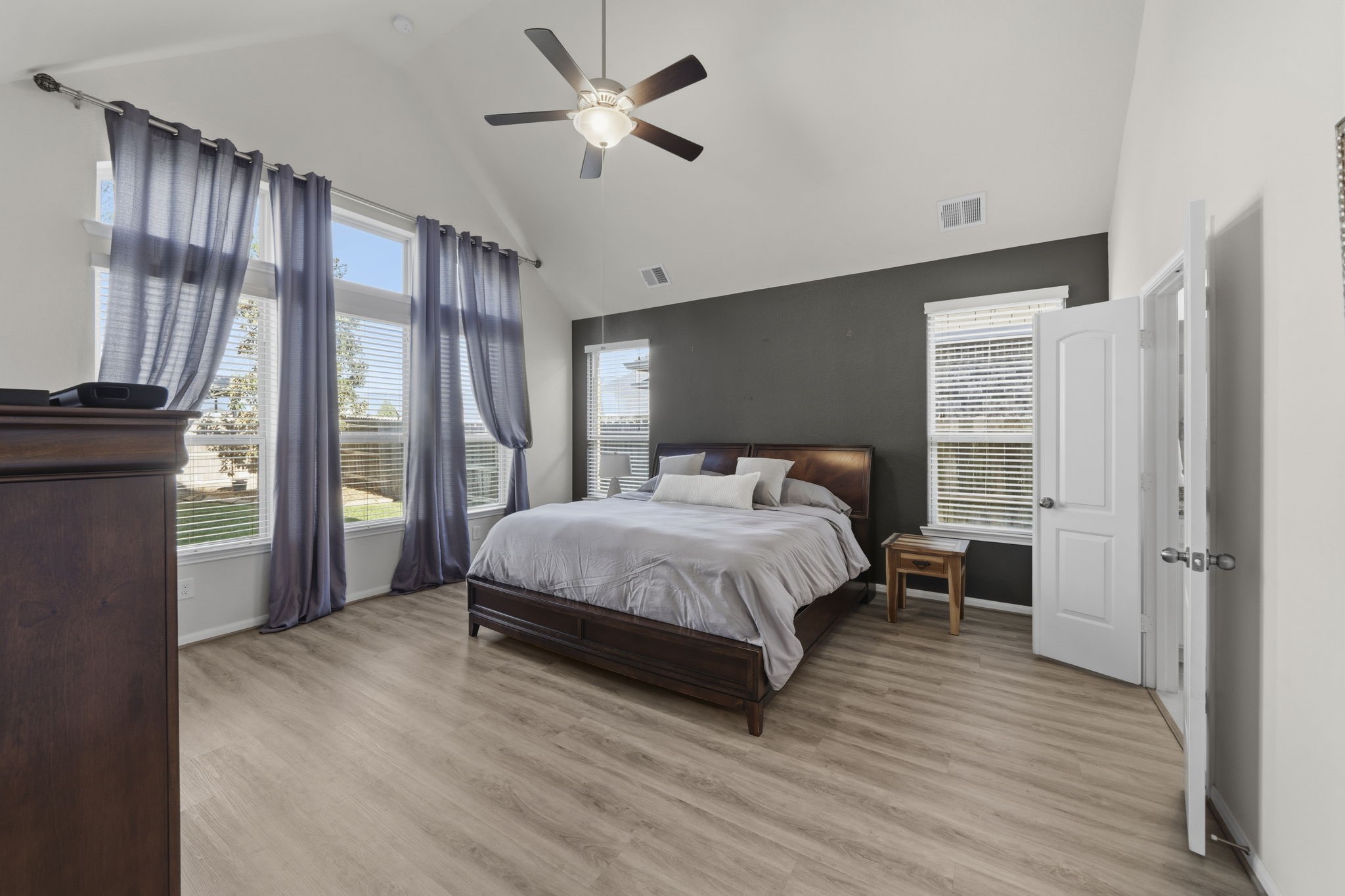 16731 Doubletree Ranch Drive Cypress, TX 77433 - Photo 15 of 44 The spacious primary bedroom has vaulted ceilings, large windows, and abundant natural light. Features a large ceiling fan, new LVP flooring.