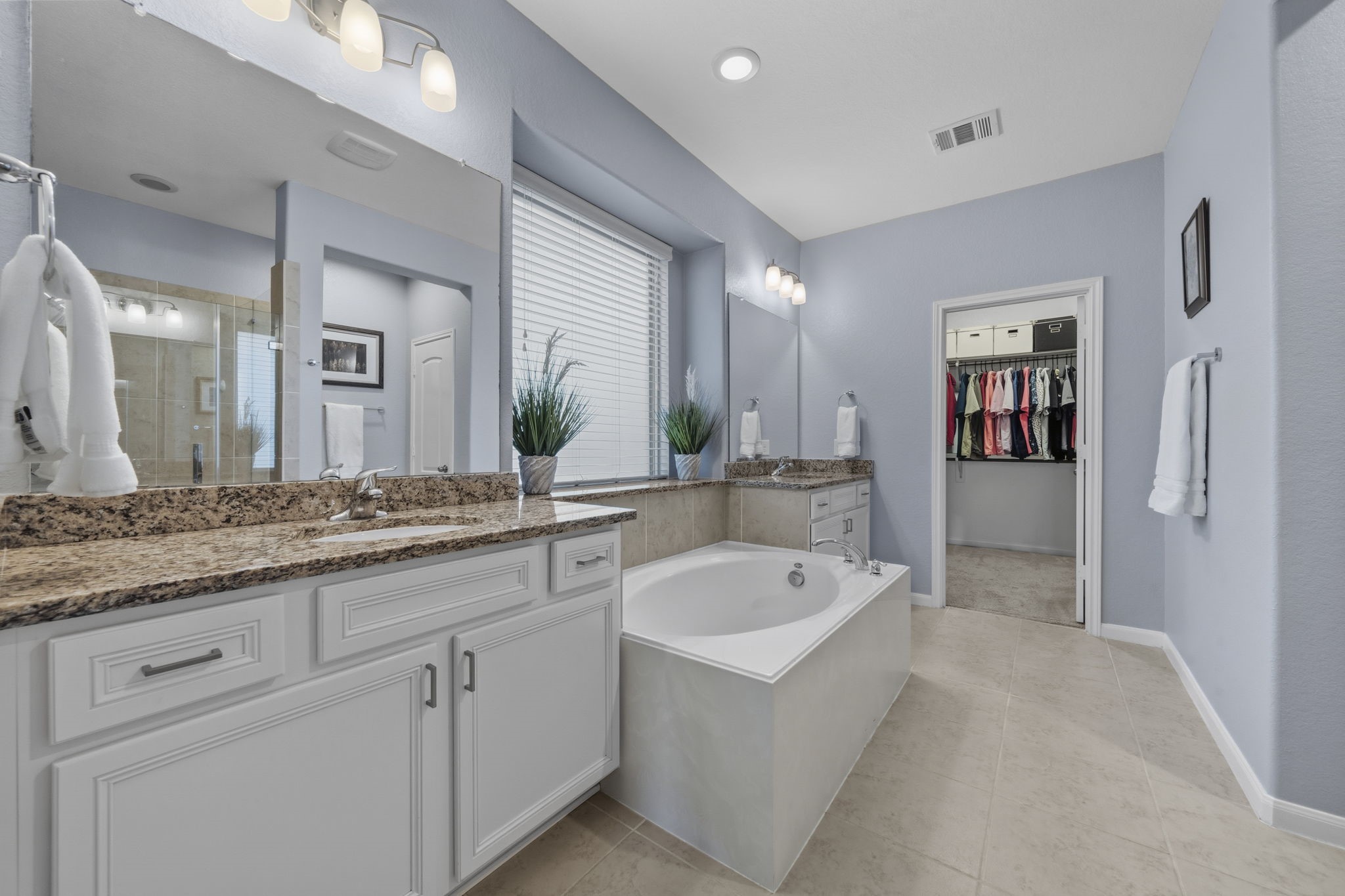 16731 Doubletree Ranch Drive Cypress, TX 77433 - Photo 17 of 44 This primary bathroom features a large soaking tub, His & Hers vanities with granite countertops, and ample cabinet space.