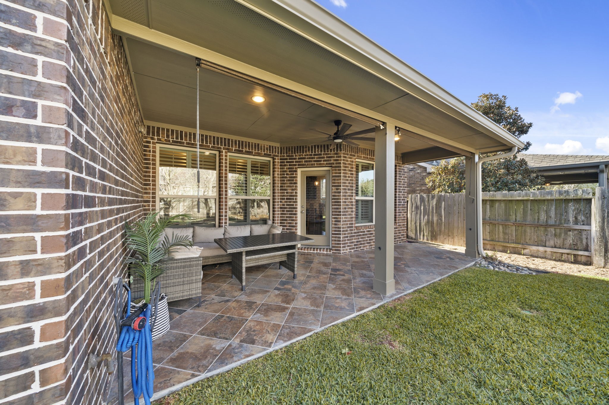 16731 Doubletree Ranch Drive Cypress, TX 77433 - Photo 30 of 44 The backyard features an oversized covered patio with large travertine tile flooring, recessed lighting, and a ceiling fan.